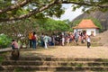 Tourists and local people crowd near entrance to Dambulla Golden