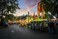 Tourists and locals enjoy the annual Pig Out in the Park in Riverfront Park, Spokane Washington, as night falls.