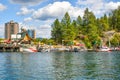 Tourists and locals enjoy the marina and lake at the boardwalk in the mountain town of Coeur d`Alene, Idaho USA