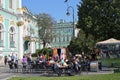 Tourists and locals enjoying the sun outside the famous Hermitage museum