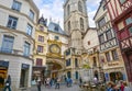 Tourists and locals pass by and under the gros horloge, the medieval astronomical clock on the main street of Rouen France