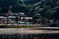 Tourists and locals sitting beside the Hozugawa river to sight see the spectacular view