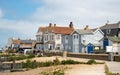 Tourists and locals walk along the seafront pathway seaside with traditional British houses in Whitstable kent England. Royalty Free Stock Photo