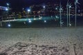 Tourists and locals walk at night along the Cairns city pool - Queensland, Australia