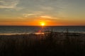 tourists and locals walking at sunset on the beach in Broome and enyoing sunset, with a big ship at the horizon, Western Australia Royalty Free Stock Photo