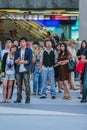 Tourists and locals watching the live broadcast on the screen on the street of wedding of Prince William and Kate Middleton. Royalty Free Stock Photo