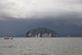 Tourists in long tail boat come to visit Golden Scale Dragon Spine Beach