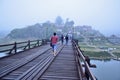 Tourists on long wood bridge