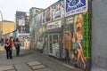 Tourists look at the drawings on the Berlin Wall. Graffiti at the East Side Gallery