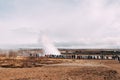 Tourists look at the eruption of a geyser. Geyser Valley in southwest of Iceland. The famous tourist attraction Geysir Royalty Free Stock Photo