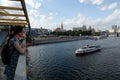 Tourists look at the Moscow river from the bridge Bogdan Khmelnitsky