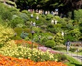 Tourists looking down into the beautiful sunken botanical garden at Butchart Gardens, Victoria, BC.
