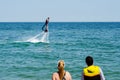 Tourists looking at a flyboard demonstration