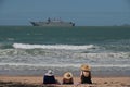 Tourists looking at HMAS Adelaide Australian landing helicopter dock ship passing by Magnetic Island Queensland Australia Royalty Free Stock Photo