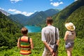 Tourists looking at mountain lake Rizza Royalty Free Stock Photo