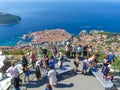 Tourists looking out over panorama view of old town of Dubrovnik