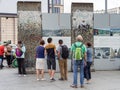 Tourists Looking At A Part of The Former Berlin Wall At Potsdamer Platz In Berlin Royalty Free Stock Photo
