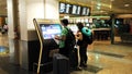 Tourists looking at screens in airport