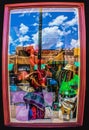 Tourists looking into shop window in Santa Fe New Mexico - people blended with merchandise and reflections of sky and buildings -