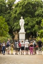 Tourists looking at statue of Cespedes Havana