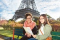 Tourists looking to map near the Eiffel Tower