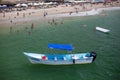 Beachgoers and boat at Los Muertos Beach