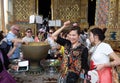 Tourists with lotus flower bathed in holy water  Grand Palace Bangkok  Thailand Royalty Free Stock Photo