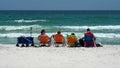 Tourists in lounge chairs on the beach