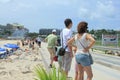 Tourists at Maho beach near Princess Juliana International Airport in Sint Maarten waiting for low flying airplane landing