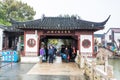 Tourists at the main entrance of wooden historic buildings in Zhujiajiao in a rainy day, an ancient water town in Shanghai, built