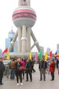 Tourists make selfies at the Pearl Tower in Shanghai, China