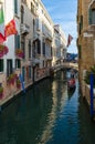 Tourists make trip on gondola on canals of Venice, Italy Royalty Free Stock Photo