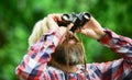 Tourists man with Binoculars Looking for something along the forest. man with binoculars telescope in the forest. Travel Royalty Free Stock Photo