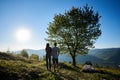 Tourists man and woman in the mountains at sunny morning