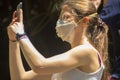 Tourists in medical masks to protect their nasopharynx but not skin. Risk of holidays in Southeast Asia. Close-up of girl from