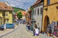 Tourists on medieval street in Sighisoara, Romania Royalty Free Stock Photo