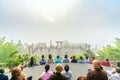 Tourists meditating in front temple as a way to relax soul