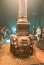 Tourists and Medusa Head Pillar in The Basilica Cistern or Yerebatan Sarnici