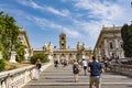 Tourists on Michelangelo stairs to Piazza del Campidoglio on top of Capitoline Hill and Palazzo Senatorio, Rome, Italy. Royalty Free Stock Photo