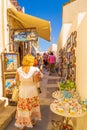 Tourists on narrow commercial street in Pyrgos Kallistis Santorini Greece
