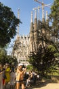 Tourists at Nativity facade of La Sagrada Familia - the impressive cathedral designed by Gaudi. Barcelona, Spain Royalty Free Stock Photo