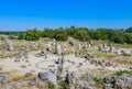 Tourists in the natural phenomenon Pobiti Kamani Royalty Free Stock Photo