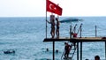 Tourists are near the beach on the pier Royalty Free Stock Photo