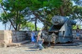 Tourists are near cannon coast howitzer of late 19th century at Montjuic Fortress, Barcelona, Spain Royalty Free Stock Photo