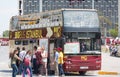 Tourists near the double-decker tour bus