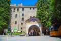 Tourists near the entrance arch of famous Rila Monastery, Bulgaria Royalty Free Stock Photo