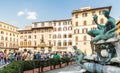 Tourists near famous fountain of Neptune on Piazza della Signoria in Florence