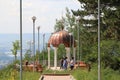 Tourists near gazebo with white columns and a copper dome Royalty Free Stock Photo