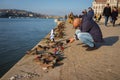 Tourists near Iron shoes memorial to Jewish people executed during WW2 in Budapest