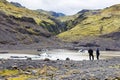 Tourists near pool of Solheimajokull glacier